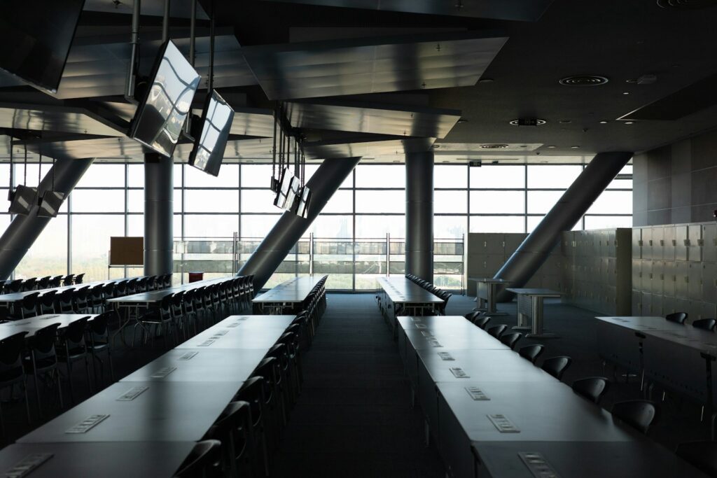 An empty modern conference hall set up with rows of delegate tables