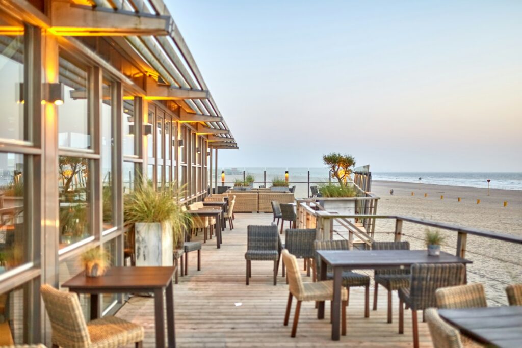 A waterfront terrace at dusk, the quieter setting the capital does better than its neighbour