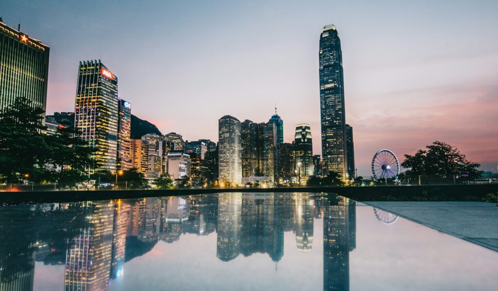 The Hong Kong skyline reflected in the harbour at dusk, host city of Art Basel Hong Kong