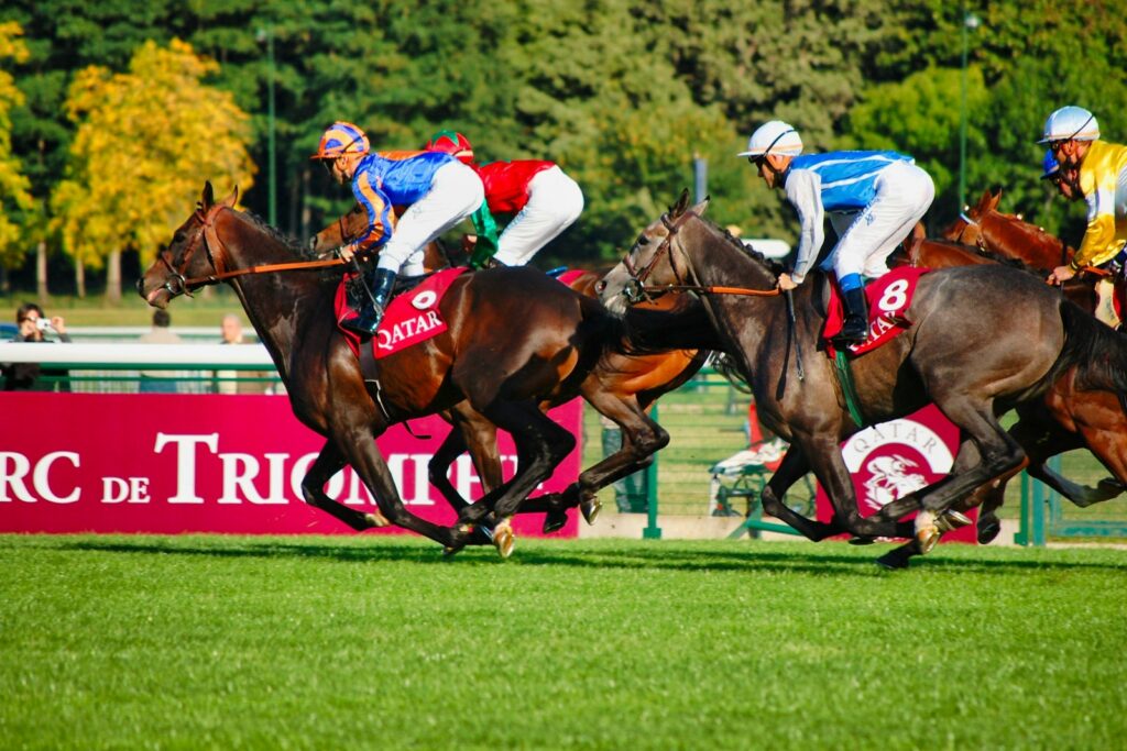 Jockeys in colourful silks racing at Royal Ascot