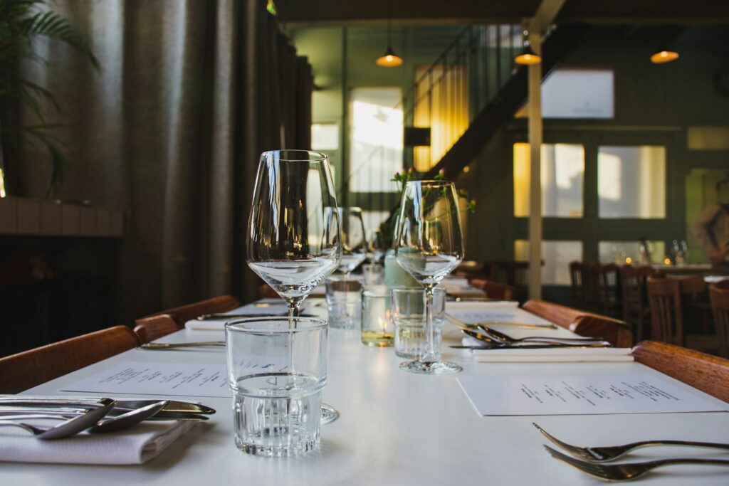 A table set for a client dinner in a private room, with the pace of the evening under the host’s control