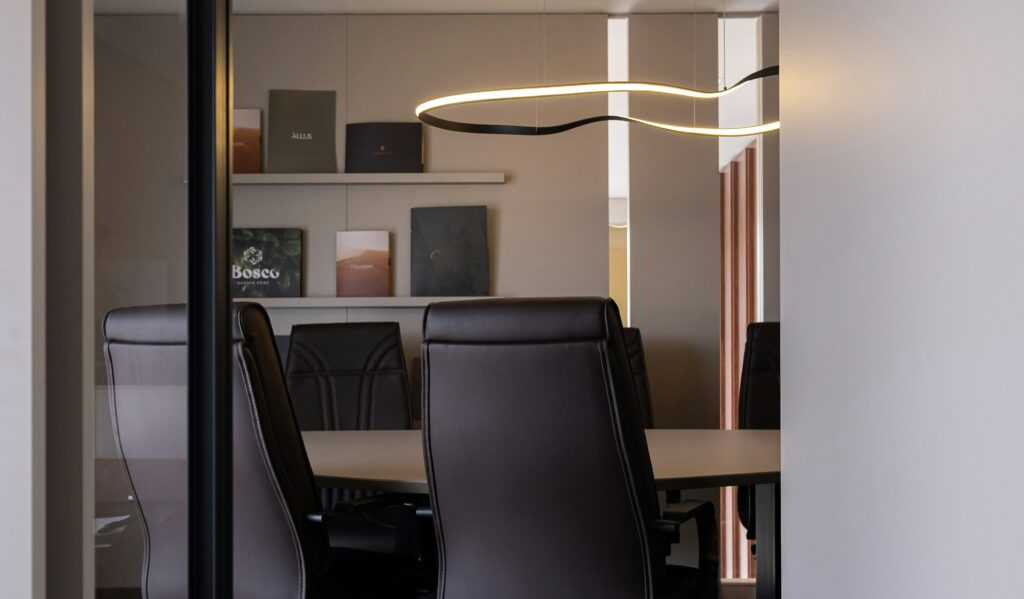 A private boardroom with a long table and leather chairs, representing the family office structure