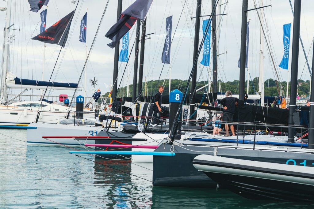 Sailing crews preparing their boats in the marina during Cowes Week, Isle of Wight