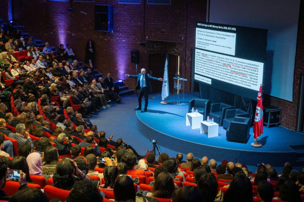 Speaker presenting to an audience during a conference session — Perfect.Live