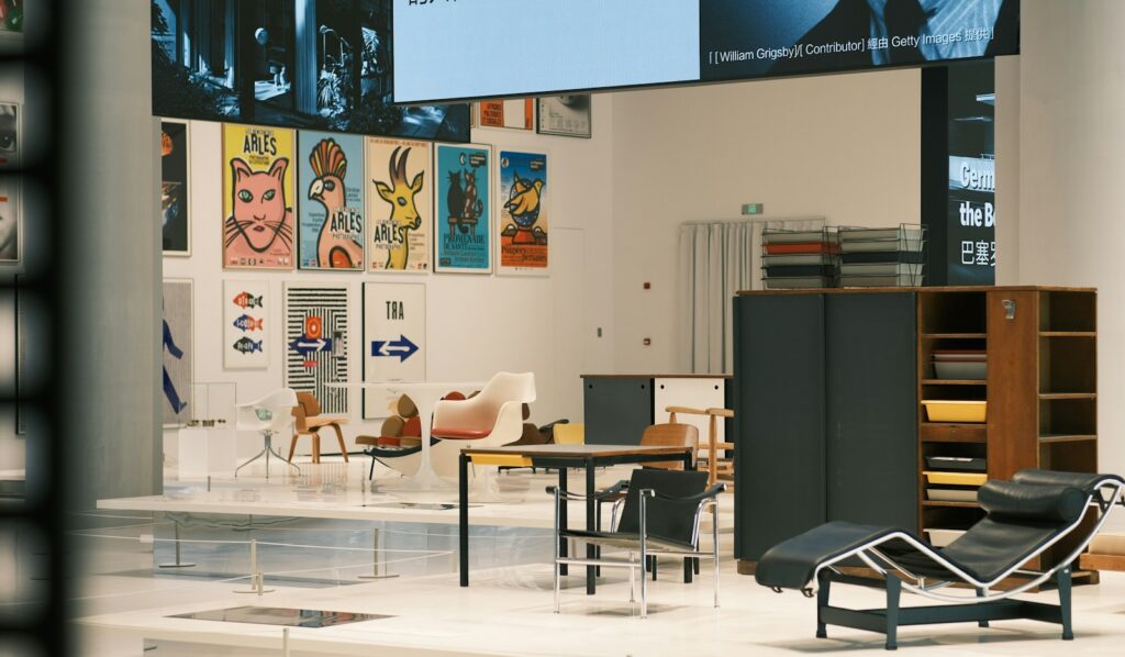 Twentieth-century furniture and lighting displayed in gallery booths at a collectible design fair