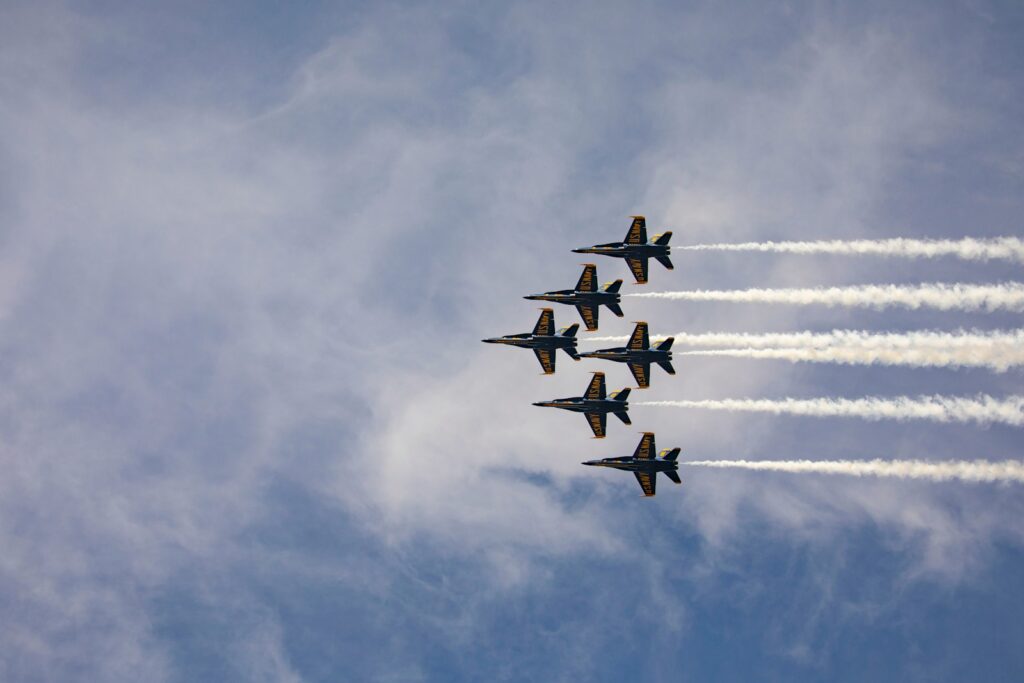 Four fighter jets in formation trailing smoke during an air show flying display