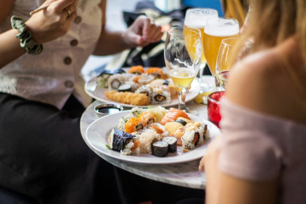 Plates and drinks going round a Dubai brunch table, where the sitting runs three to four hours