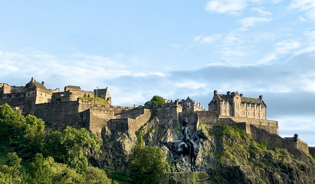 Edinburgh Castle rising above the Old Town rooftops, seen from Princes Street