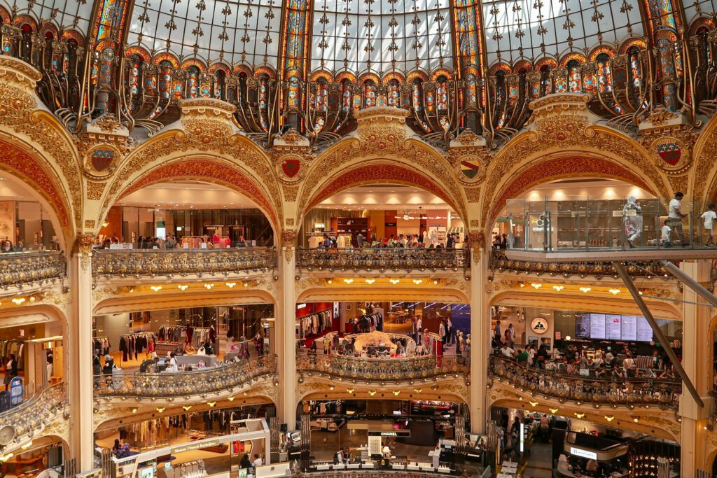 Balconied sales floors beneath the glass dome of a grand Paris department store