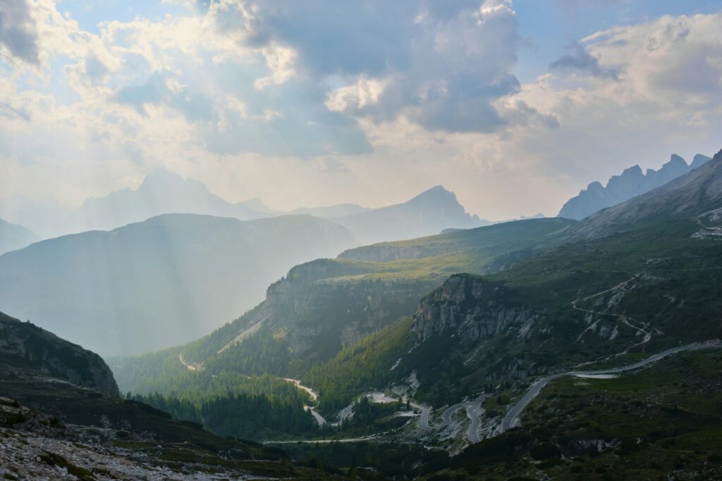 A road winding through a Dolomite valley below the peaks