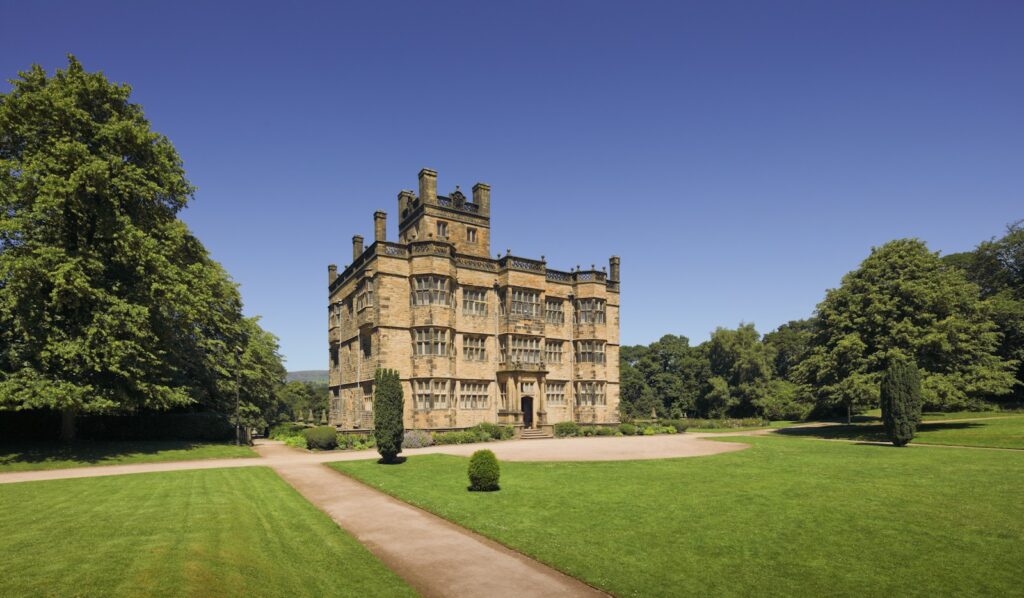 Grand historic English country house set among lawns and trees