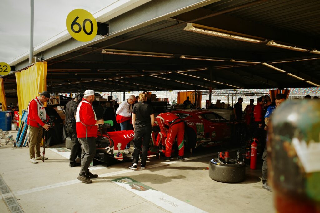 Open paddock with spectators beside the cars — Perfect.Live