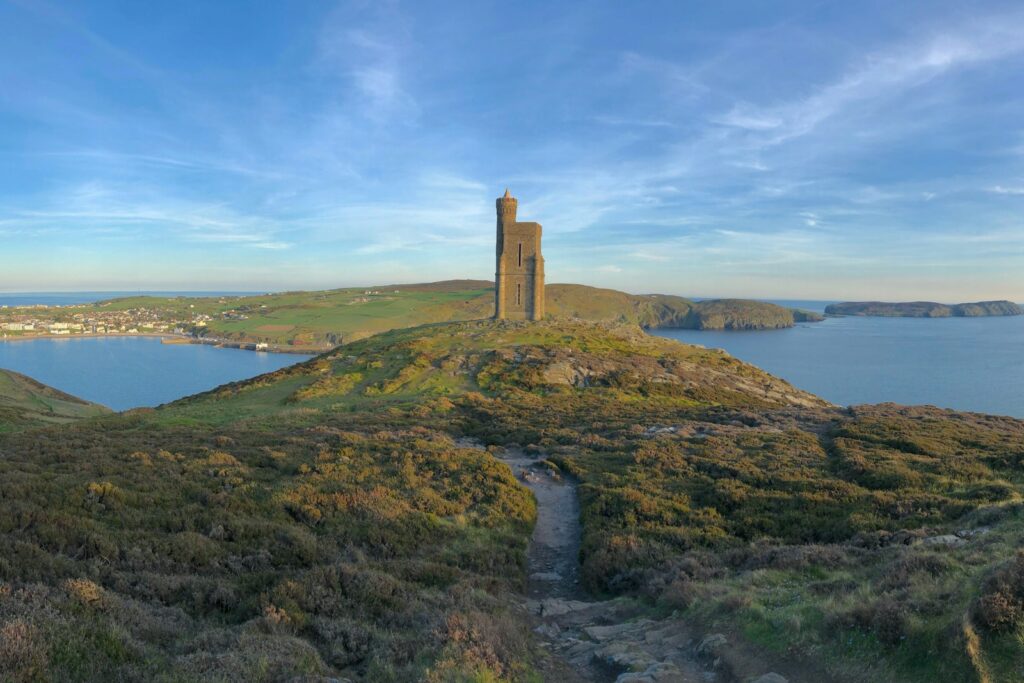 A stone tower on a headland above a bay on the island coast