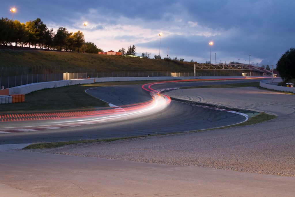 Formula 1 car at speed under floodlights — Perfect.Live
