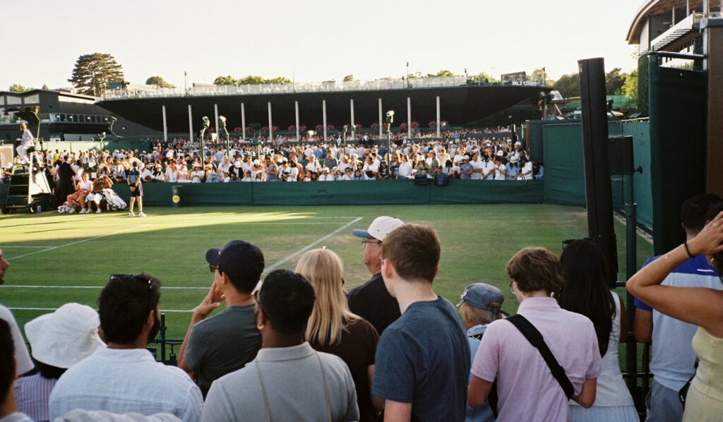 A crowd watches a grass-court tennis match from packed stands, the kind of atmosphere the Laver Cup is known for