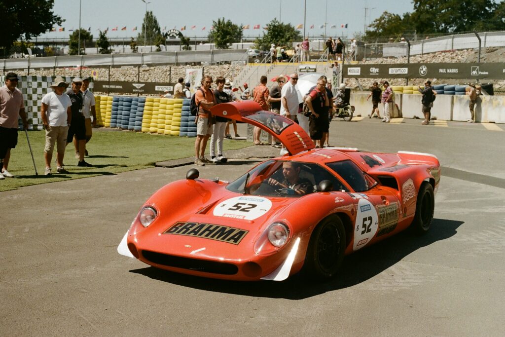 Vintage racing car powering through a corner in bright sunshine
