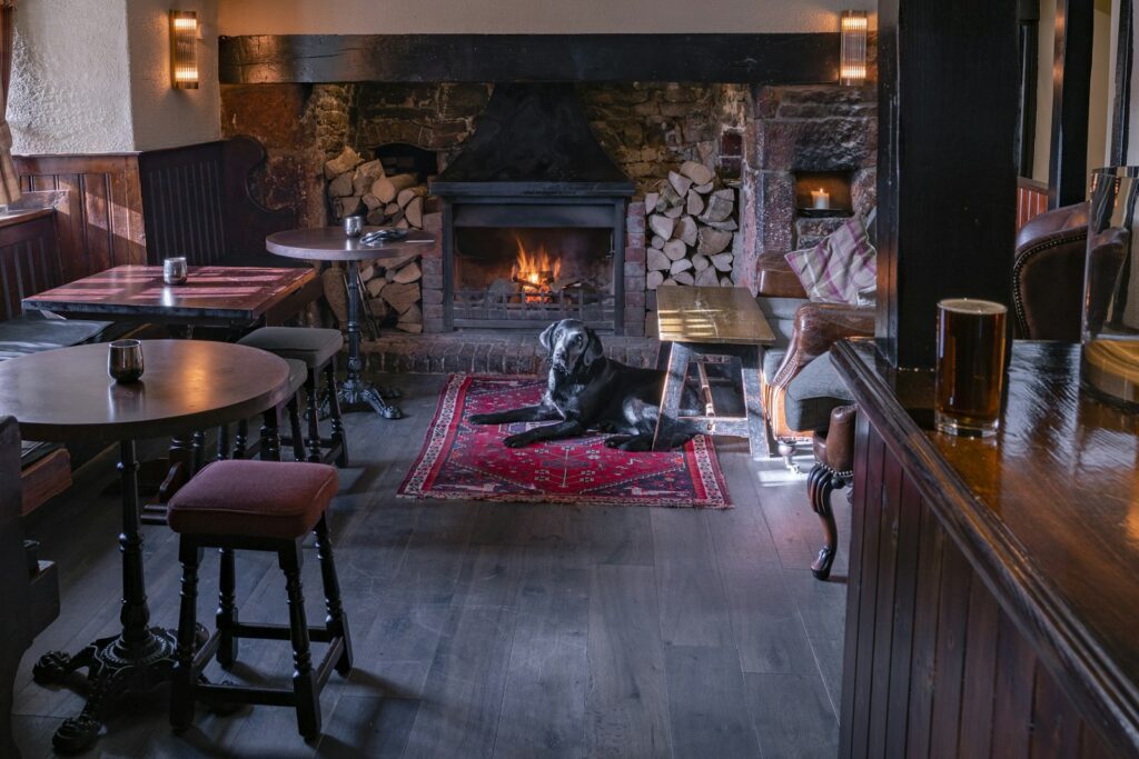 The fireside dining room of a traditional London pub laid for Sunday lunch