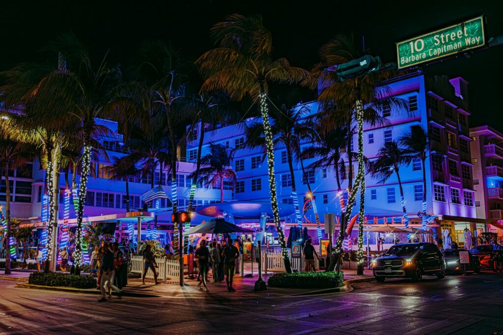 Ocean Drive at night during an event week, when the city’s best tables are committed days in advance