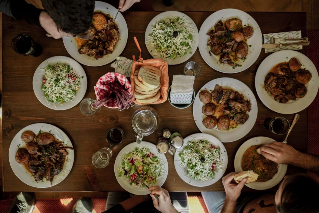 A shared table of plates for a group with mixed dietary needs, the most common booking we handle