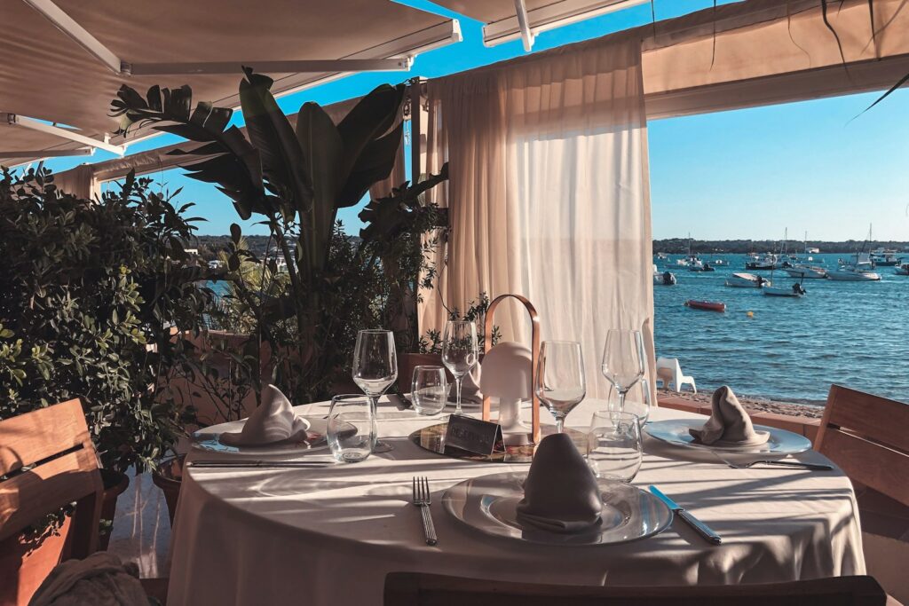 A terrace table set above the water, the harbourside alternative to the casino dining rooms