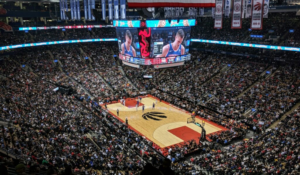 Basketball arena packed for a Finals game with the court lit — Perfect.Live