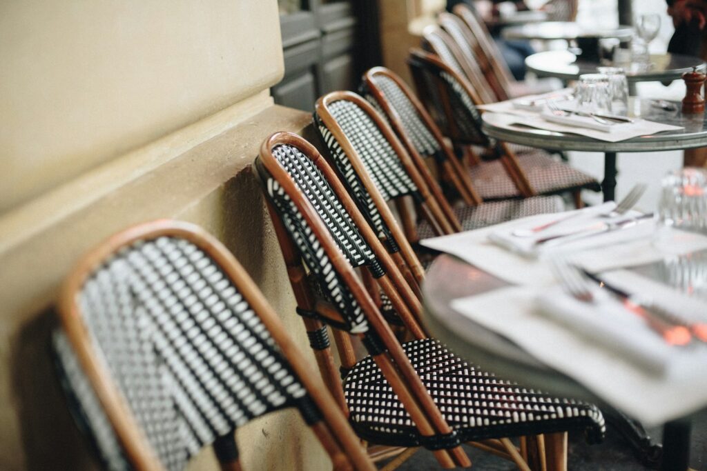 Terrace tables in Paris, where availability compresses sharply around Fashion Week and the auction season