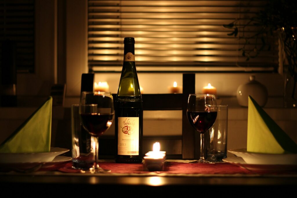 A candlelit table laid for two, the setting that disappears first around Valentine’s Day and New Year’s Eve