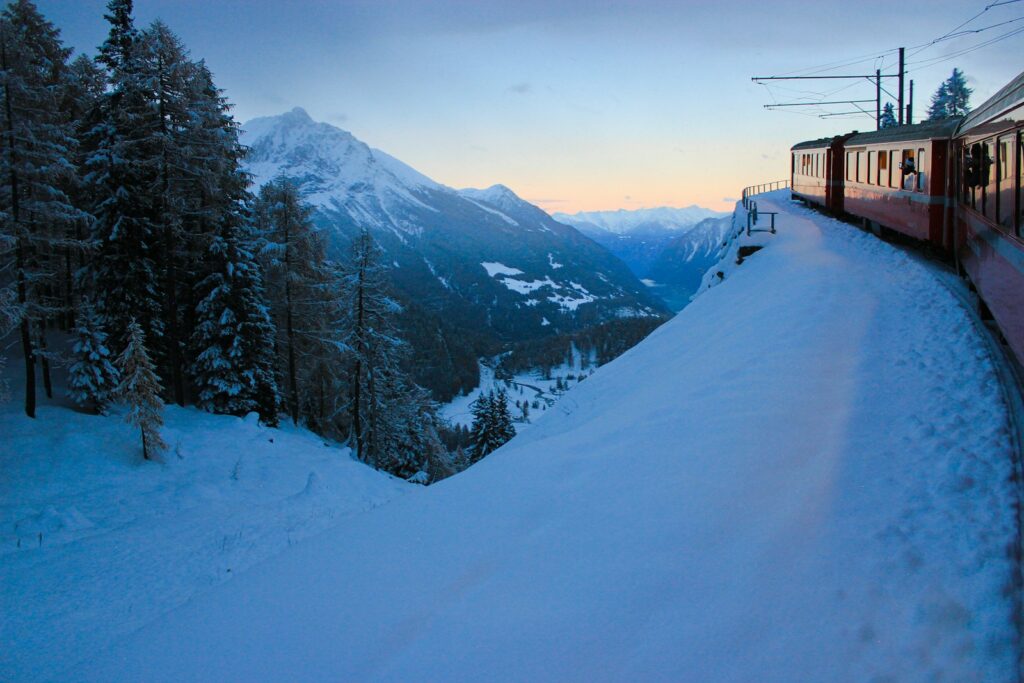 Rhaetian Railway train crossing the snow-covered Engadin towards St Moritz