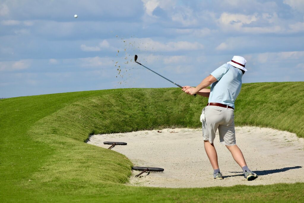Golfer striking a tee shot during competition — Perfect.Live