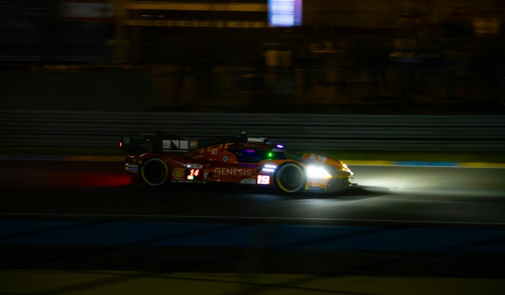 A Formula One car racing at night under floodlights, the format used for the Singapore Grand Prix