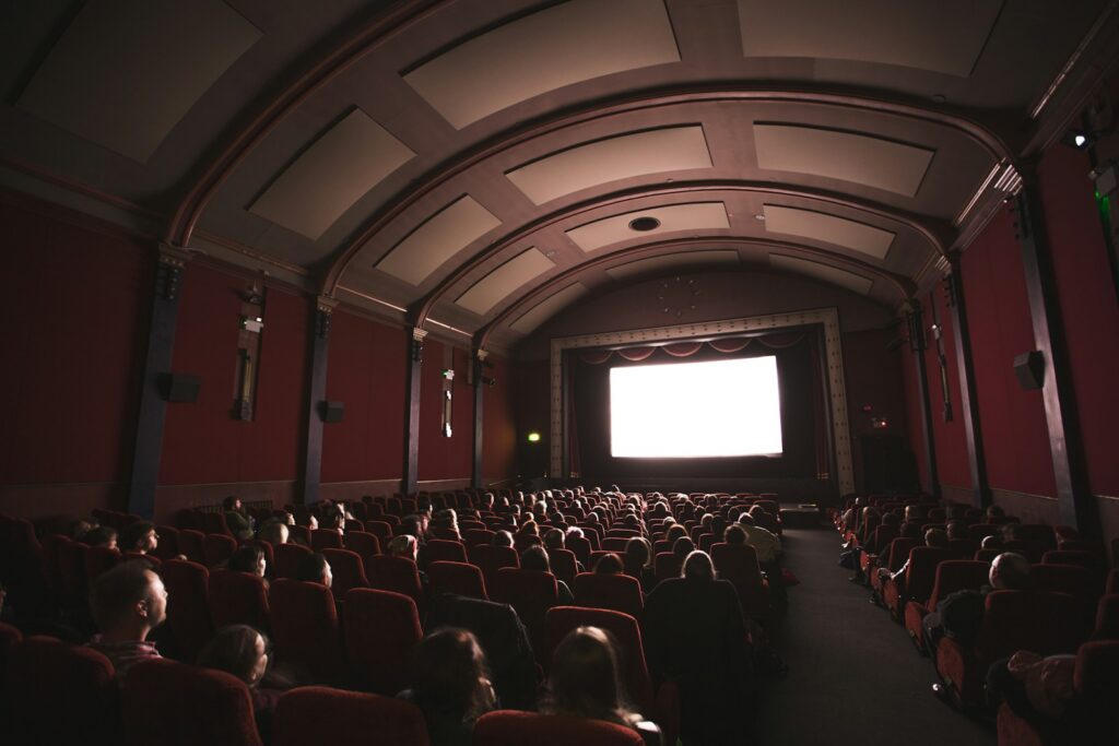 Audience in a darkened cinema during a festival screening — Perfect.Live