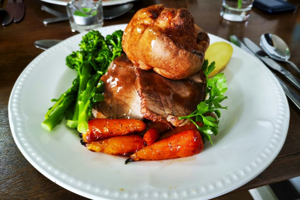 A plated Sunday roast with Yorkshire pudding and seasonal vegetables at a London gastropub
