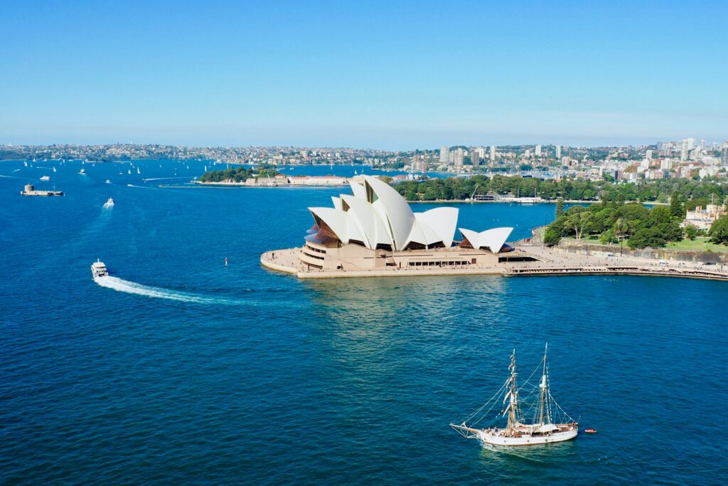 Sydney Harbour with the Opera House and a tall ship under sail