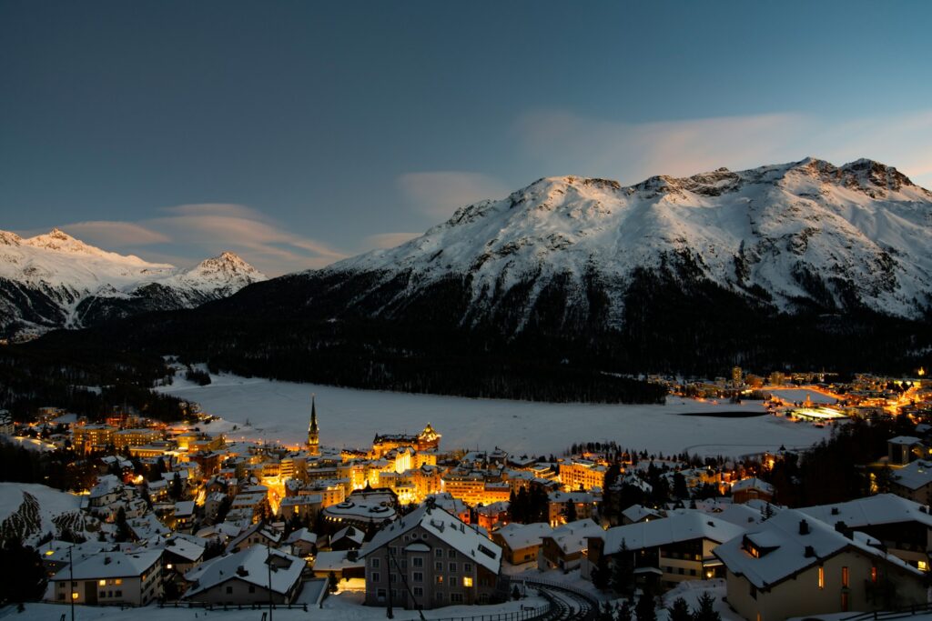 St Moritz lit at dusk beneath the Engadin mountains