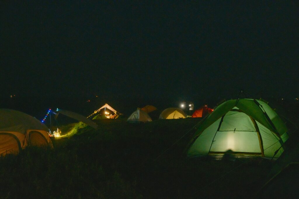 Illuminated tents in the DreamVille campsite at night