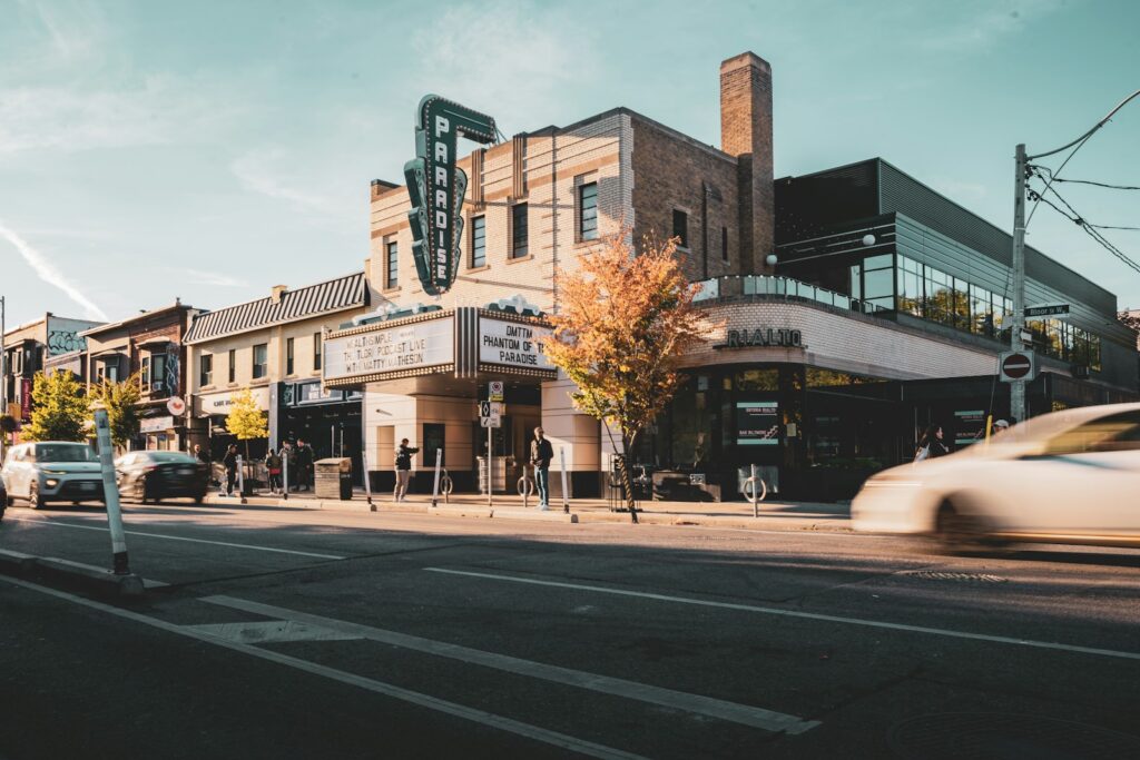 A historic cinema marquee on a Toronto street corner