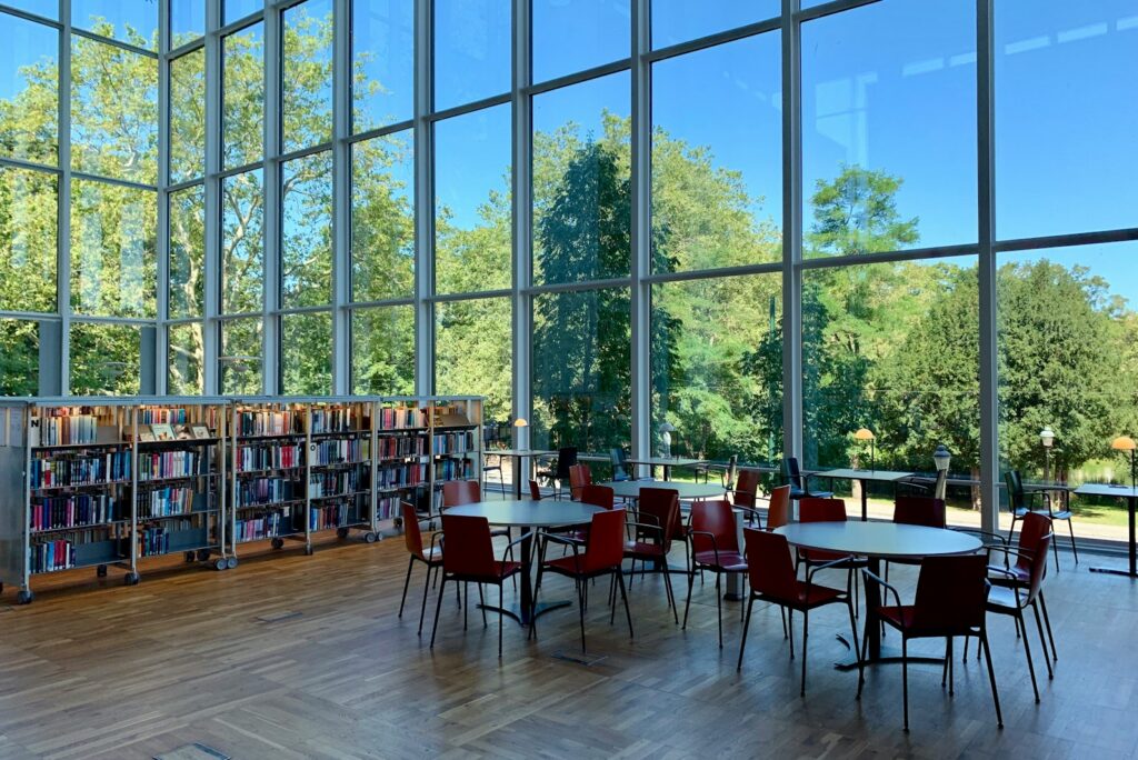 A private library with tall windows looking onto grounds, the kind of room where long-horizon decisions get made