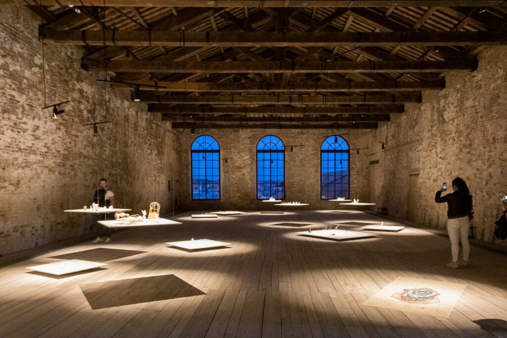 Exhibition installed in a brick and timber hall of the Arsenale at the Venice Biennale