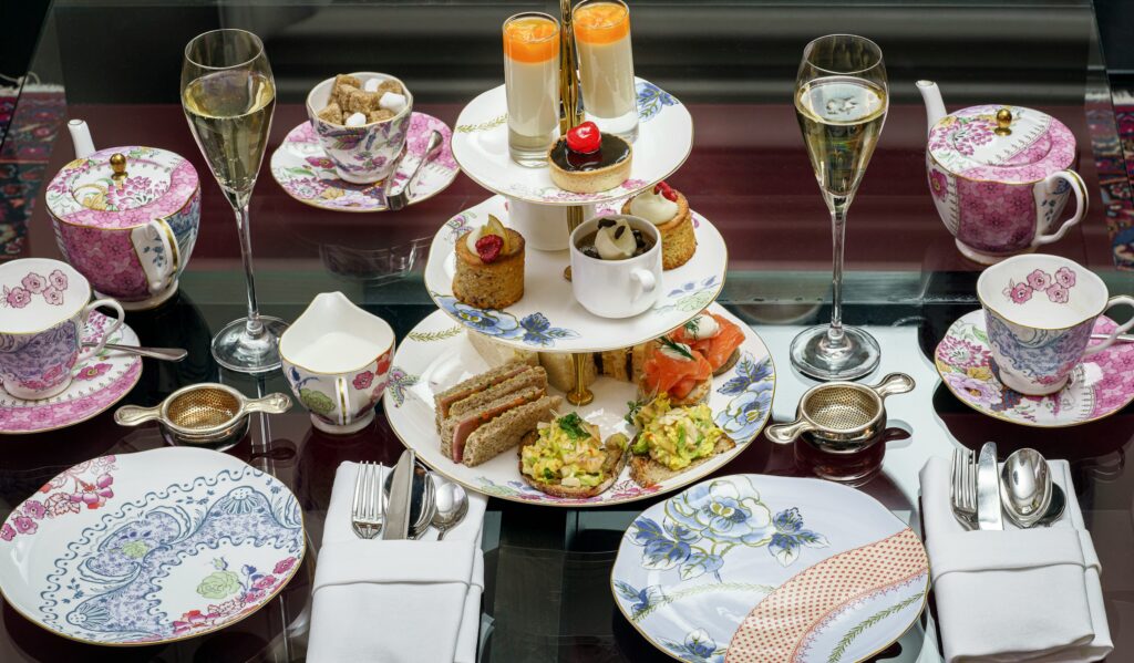 Tiered stand of sandwiches and pastries with tea and champagne, set for afternoon tea New York