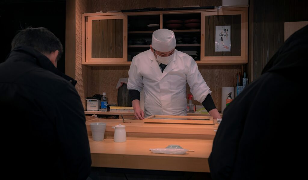 Chef working at a quiet wooden counter, the kind of room found among the best restaurants in Tokyo