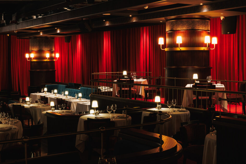 Billionaire Dubai dining room with red velvet curtains and candlelit tables