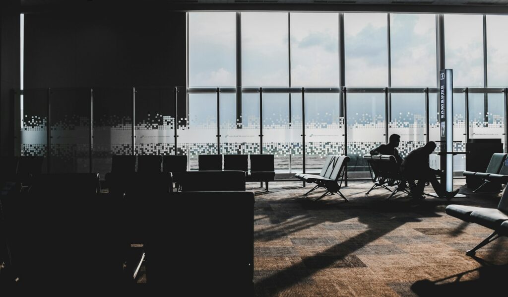 Business travel concierge services — an executive working in a quiet airport lounge before a flight
