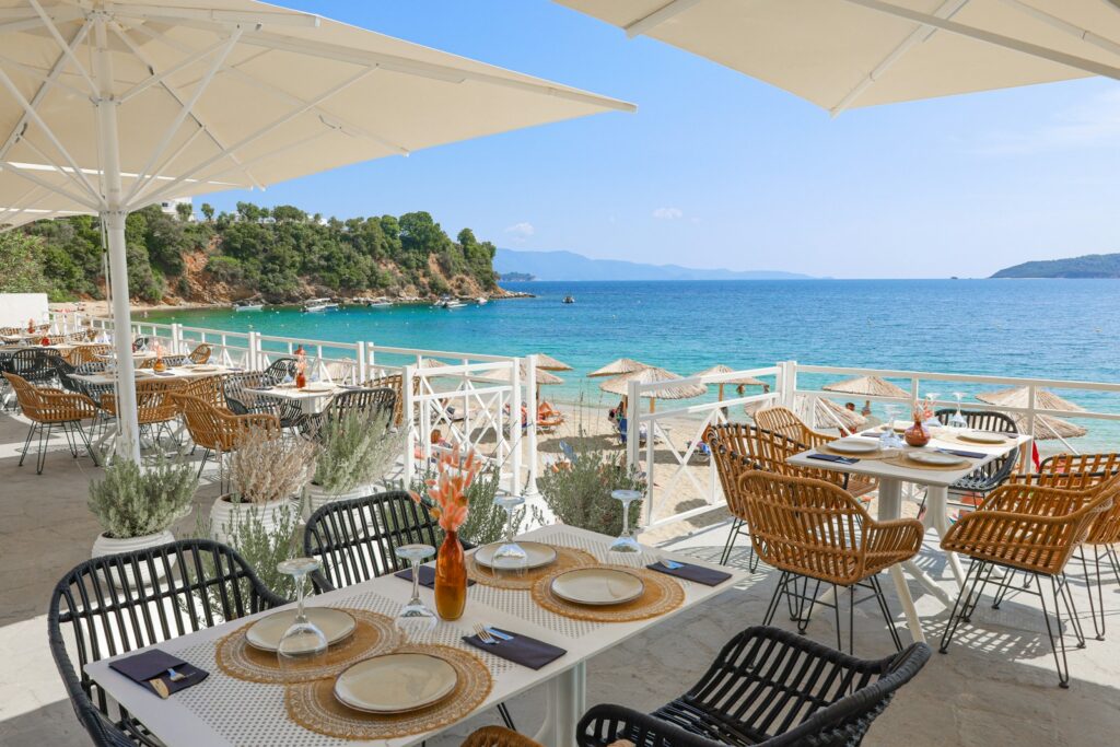 A white-clothed beach restaurant terrace on the Cannes coastline