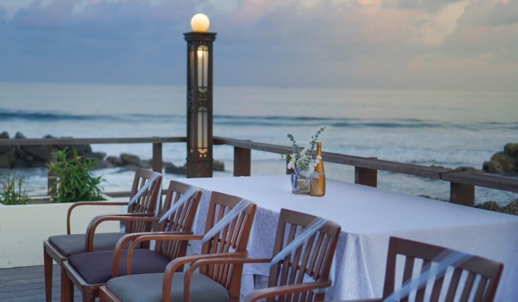 Restaurants Cannes Film Festival guests book — a terrace table overlooking the bay of Cannes at sunset