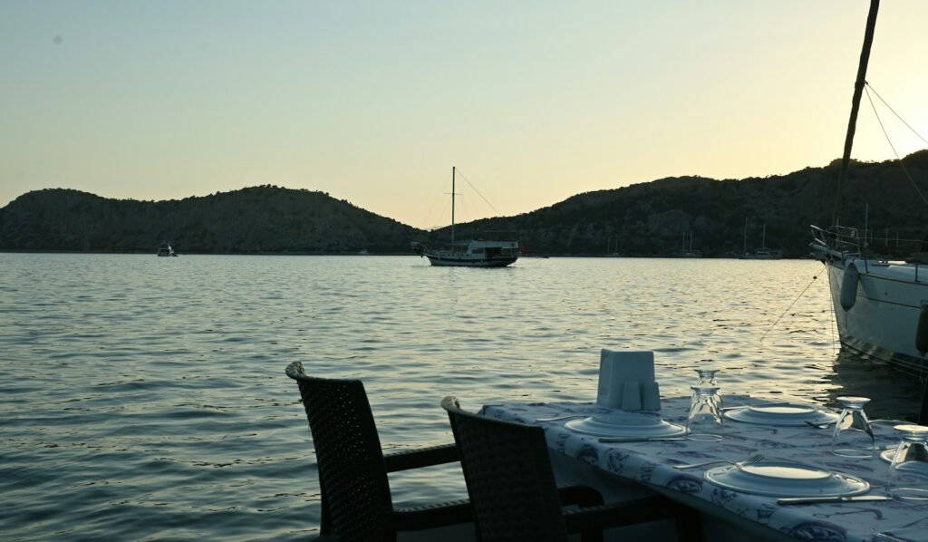 Cannes Film Festival tickets — a terrace set for dinner above the bay at dusk
