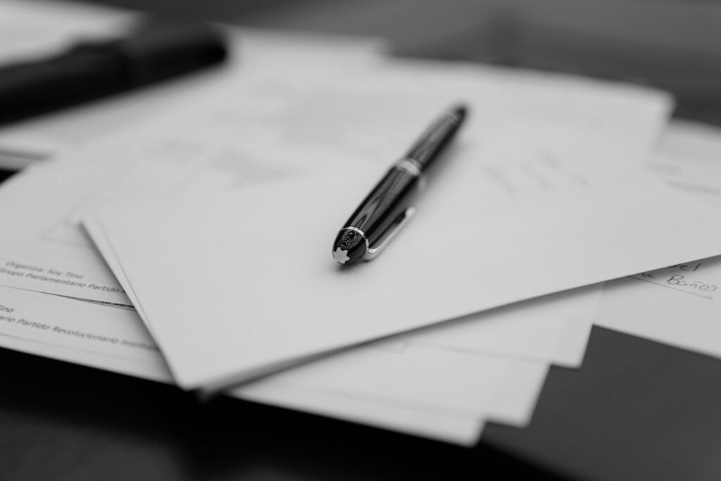 A pen resting on a stack of service documents