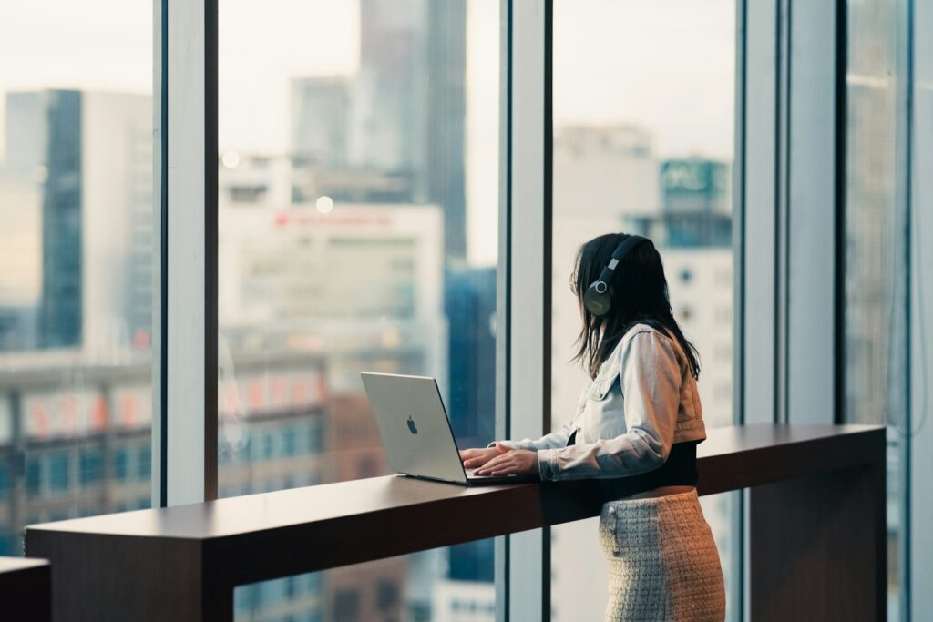A professional working on a laptop in a high-rise office