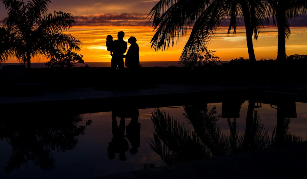 Executive and family on a villa terrace at dusk, lifestyle management for executives | Perfect.Live