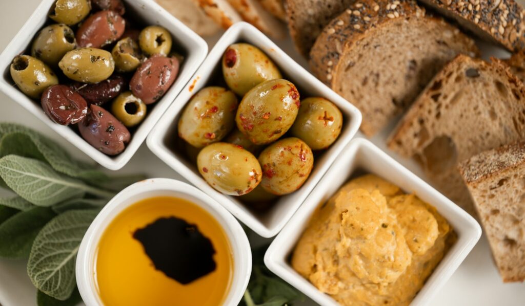 Gaia Dubai vegetarian menu — Greek salad, meze, and olive oil on a marble table in DIFC