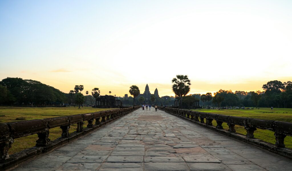 Heritage travel — early morning on the stone causeway leading to Angkor Wat